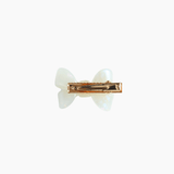 The KIKI and JOJO Girls Iridescent Sheer Double Bow Hair Clip in ivory features a pearlized white double bow design, exuding playful elegance, and is shown from the back against a plain white background.