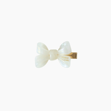 The Girls Iridescent Sheer Double Bow Hair Clip in ivory by KIKI and JOJO features a glossy double bow with a gold metal clasp, exuding playful elegance against a simple white background.