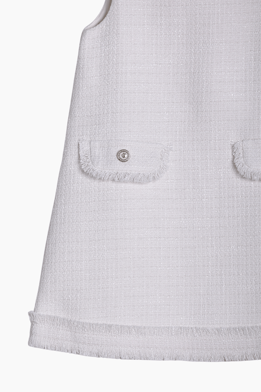 Close-up of the KIKI and JOJO Girls Pearlescent Elegance Tweed Dress in Soft Champagne, featuring two fringed front pockets, pearlescent gold threads, and a round metal button on the left pocket.