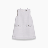 KIKI and JOJO's Girls Pearlescent Elegance Tweed Dress in Soft Champagne features a sleeveless design, textured tweed with gold threads, two front pockets, and fringe hem—ideal for elegant outings. Shown on white background.
