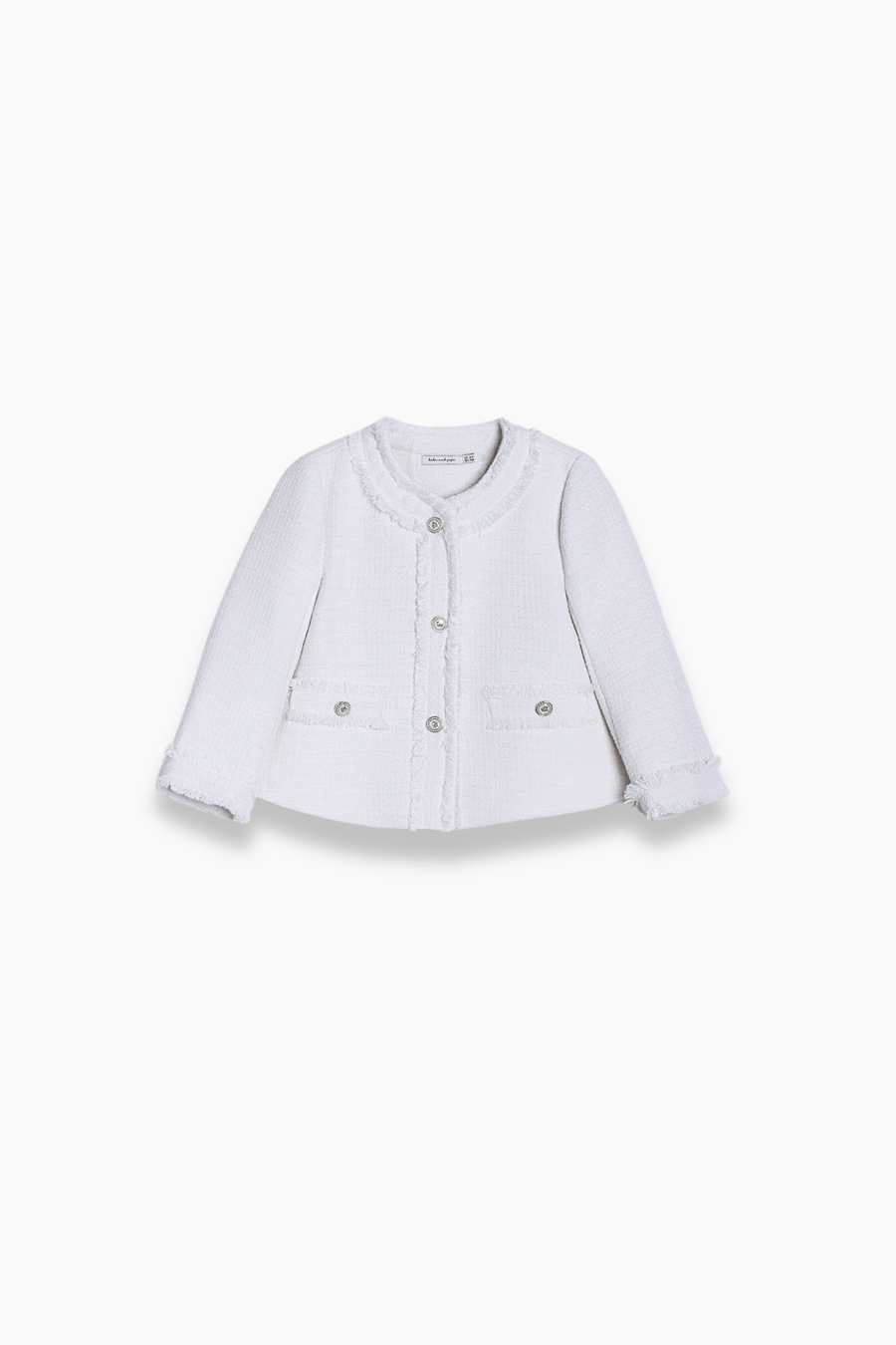 The KIKI and JOJO Girls Pearlescent Elegance Tweed Jacket in Soft Champagne is a white, long-sleeve, button-up jacket with two front pockets and decorative trim, displayed on a plain white background.
