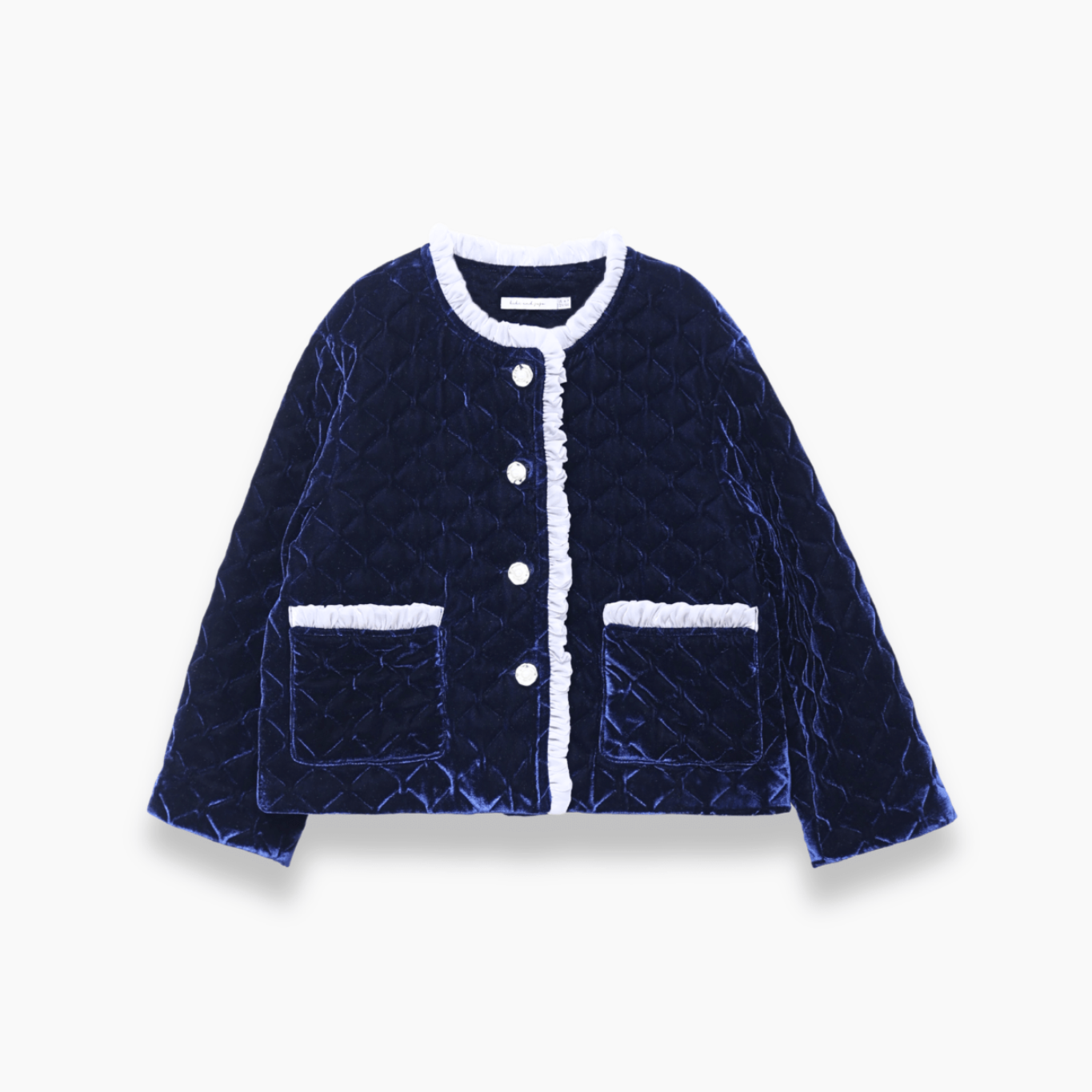 The KIKI and JOJO Girls Quilted Ruffle Jacket in Sapphire Blue features a diamond-quilted design, white trim, petal-shaped buttons, and two front pockets, shown on a plain white background.