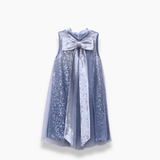 The KIKI and JOJO Girls Sequin Tulle Dress in Starlight Blue features a sleeveless design, sequin embroidery, sheer overlay, and a large metallic bow on the chest, displayed against a white background.