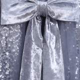 Close-up of a large silver velvet bow on the shimmering sequin embroidery of the KIKI and JOJO Girls Sequin Tulle Dress in Starlight Blue.