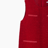 The KIKI and JOJO Girls Tweed Dress in cranberry red features a sleeveless A-line silhouette, textured fabric, and two front slit pockets, ideal for festive occasions. Shown against a white background.