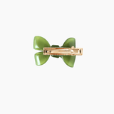 The KIKI and JOJO Girls Sheer Double Bow Hair Clip in Moss Olive features a pearl-like shimmer, a gold metal clasp, and is shown from the back on a white background.