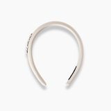 The Girls Silk Satin Jeweled & Padded Headband in Champagne by KIKI and JOJO, shown from above on a white background, offers a minimalist yet radiant look—ideal for pairing with diamanté accessories on special occasions.