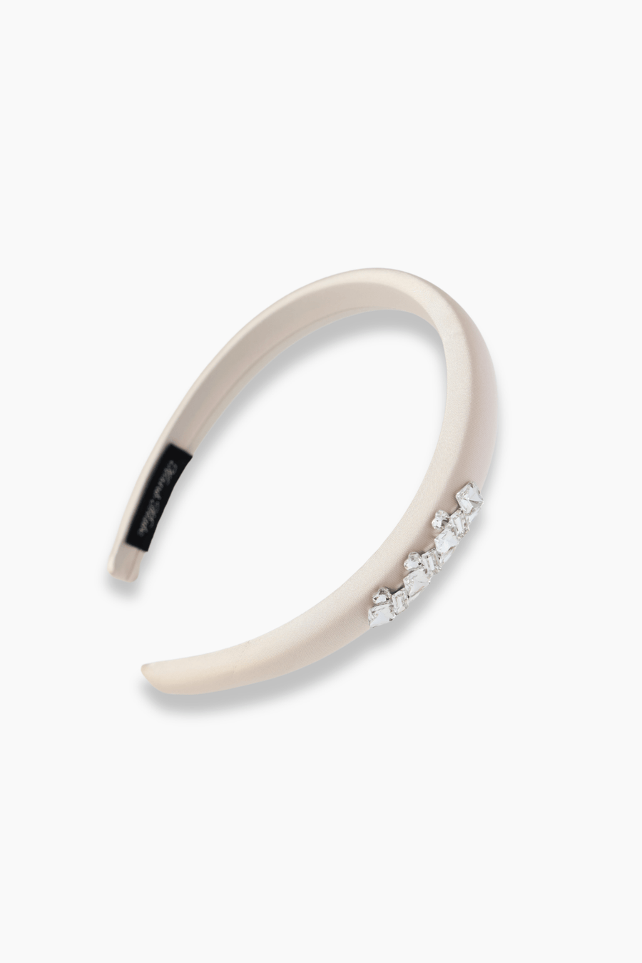 KIKI and JOJO Girls Silk Satin Jeweled & Padded Headband in Champagne features a row of sparkling diamantés on one side, shown against a white background.
