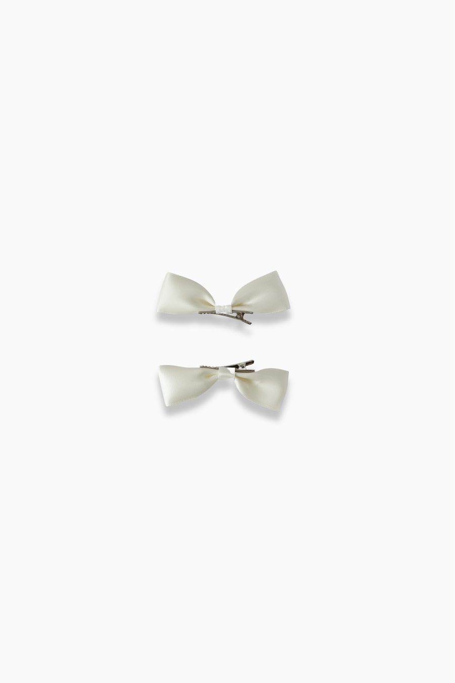 The KIKI and JOJO Girls Silk Satin Ribbon Bow Hair Clips (2 Pack) in ivory feature elegant bows and secure snap backs—an adorable accessory for girls, ideal for any occasion.