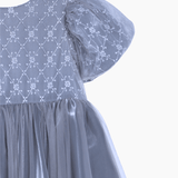 A close-up of the KIKI and JOJO Girls Velvet Asymmetrical Hem Puff Sleeve Dress in gray, featuring short puff sleeves and an elegant asymmetrical hem.