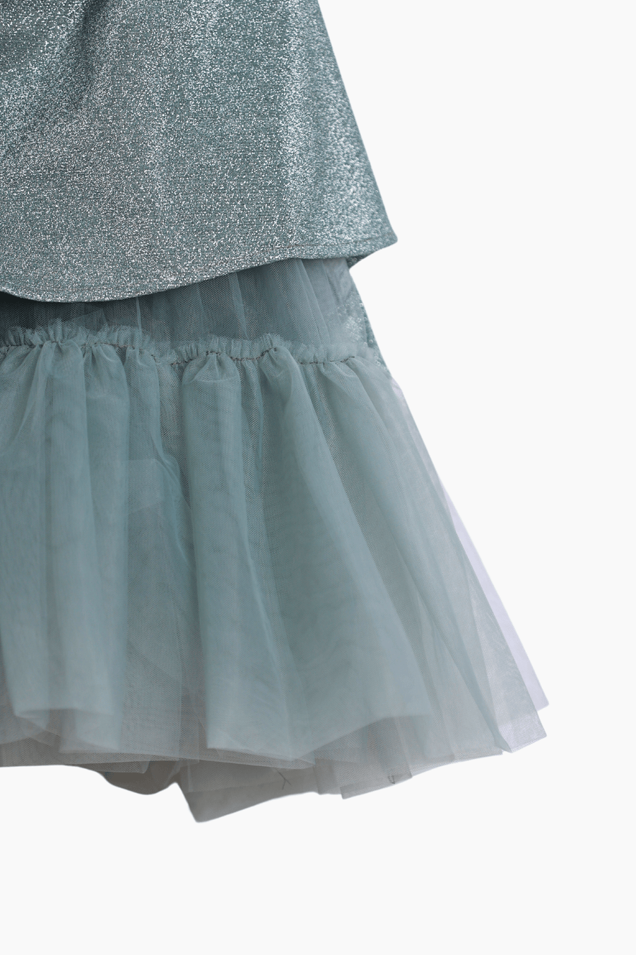 Close-up of a layered skirt with a shiny metallic top and sheer blue-gray tulle bottom—ideal for pairing with the KIKI and JOJO Girls Velvet Puff Sleeve Dress with Rhinestone Trim in Forest Green for special occasions.