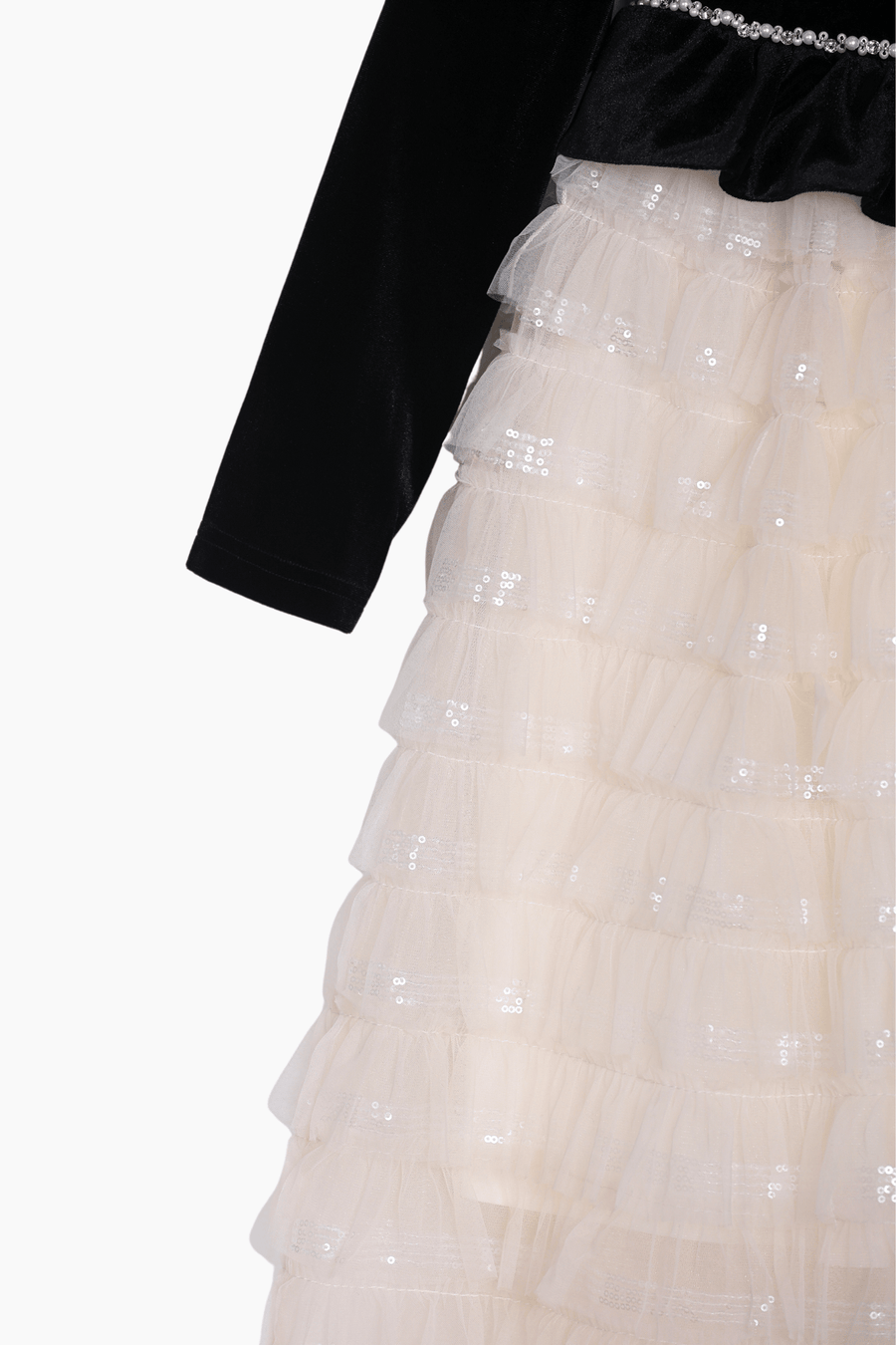 A close-up of the KIKI and JOJO Girls Velvet & Tulle Sparkle Dress in Black/Ivory, featuring a black long-sleeve top and a layered ivory tulle skirt adorned with sequins.