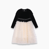 The KIKI and JOJO Girls Velvet & Tulle Sparkle Dress in Black/Ivory features a velvet top and a layered tulle skirt, displayed on a white background.