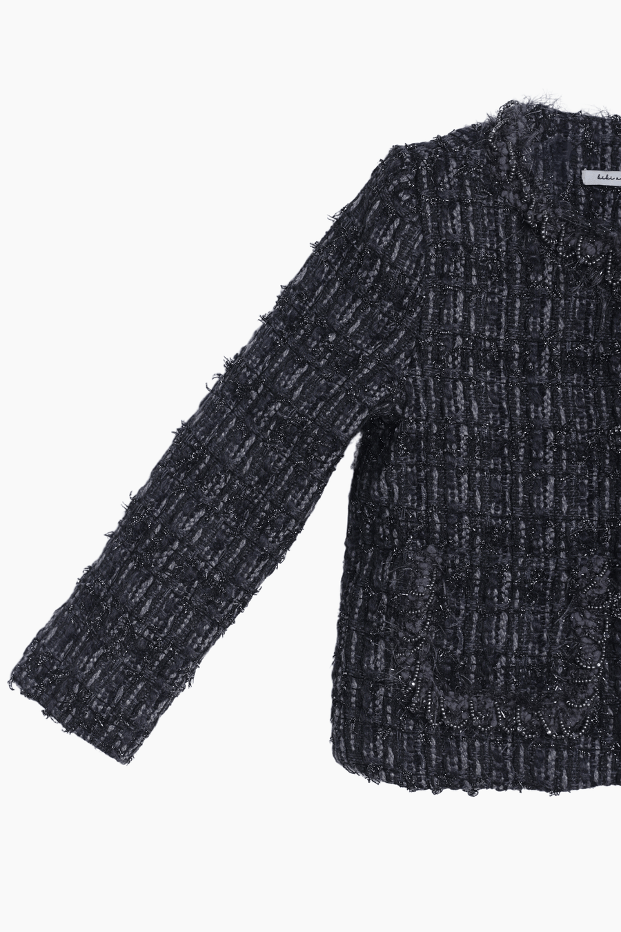 The KIKI and JOJO Girls Vintage Beaded Tweed Jacket in gray features long sleeves, vintage-inspired elegance, beaded detailing, and two front pockets—sophisticated children’s outerwear shown on a plain white background.