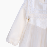 A close-up of the KIKI and JOJO Girls Vintage Lace Satin & Tulle Dress in beige, featuring puffed sleeves, a sheer skirt, and delicate hand-embroidered floral details, shown on a white background.