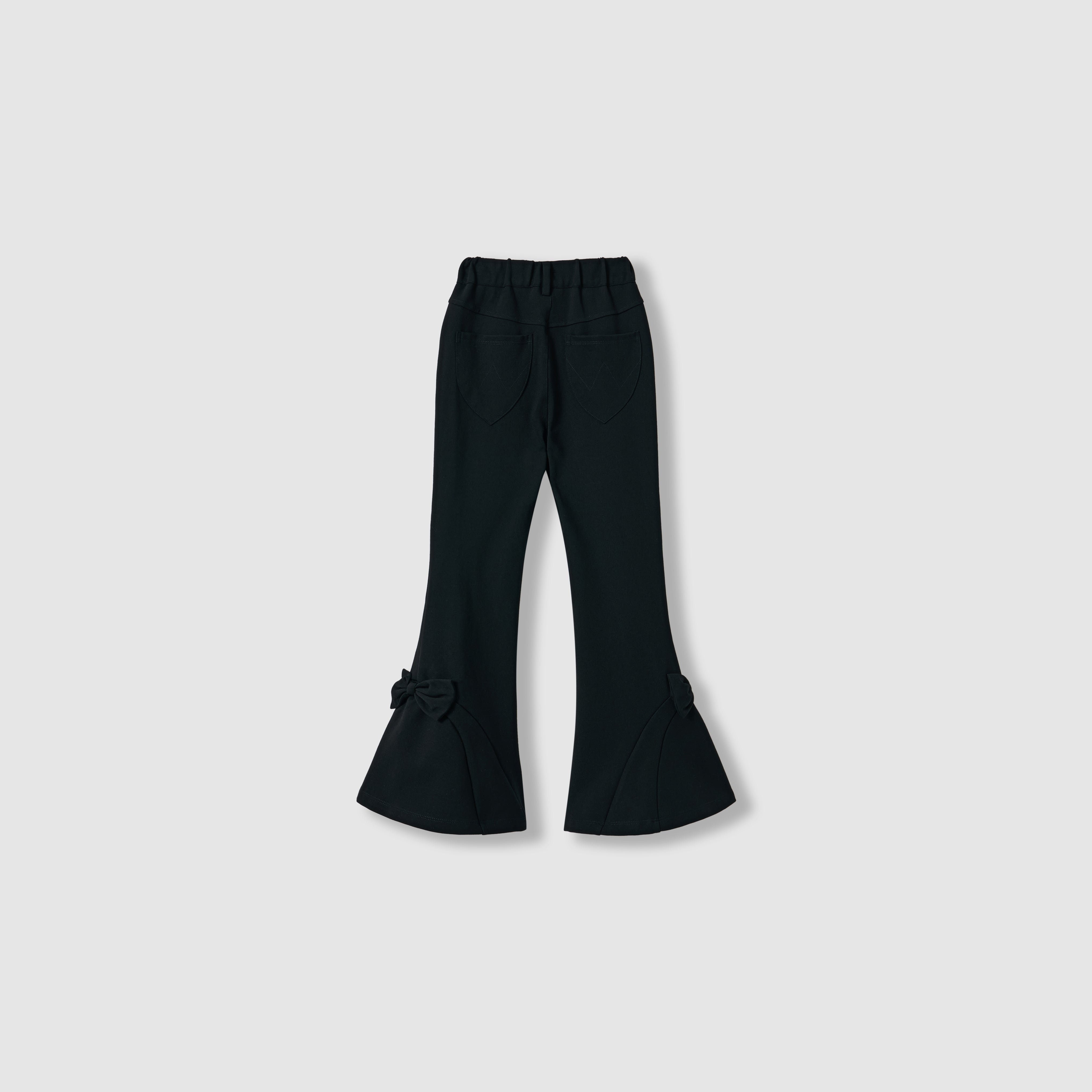 The Petal Whisper Dress Pants by KIKI and JOJO feature a black flared silhouette, elastic waistband, back pockets, and bow details at the hem. Made from stretchy fabric, they're shown against a plain light background.