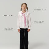A young girl models KIKI and JOJO Echo Whisper Dress Pants, standing forward in a white blouse with a pink tie. Chest, hip, waist, and shoulder measurements are shown beside her height and weight for size reference.