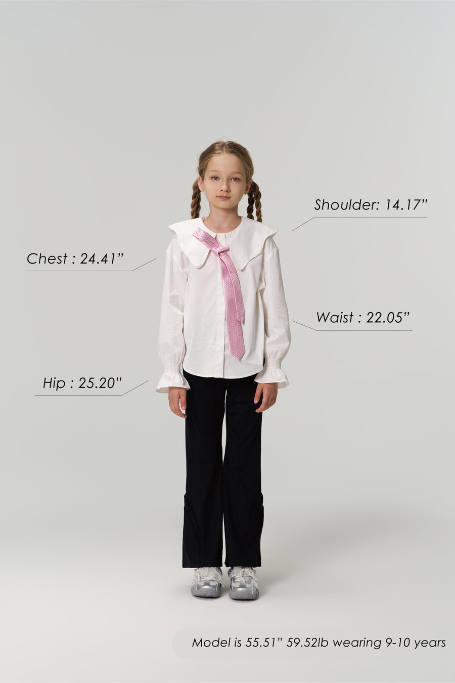 A young girl models KIKI and JOJO Echo Whisper Dress Pants, standing forward in a white blouse with a pink tie. Chest, hip, waist, and shoulder measurements are shown beside her height and weight for size reference.