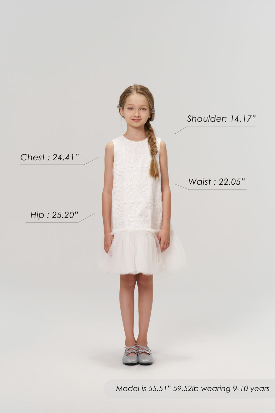 A young girl models the KIKI and JOJO Twinkle Whisper Dress, a white A-line style with delicate embroidered lace, paired with gray shoes. She is 55.51" tall, weighs 59.52 lb, wears size 9-10 years; chest, shoulder, waist, and hip labeled.
